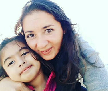 Victoria, a young girl with LC-FAOD poses with her mother, Myriam